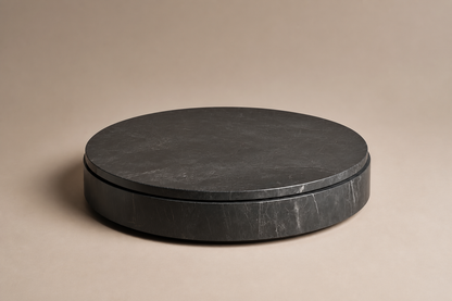 Concave Groove Base Disc black marble plinth base by 1-OPH, three-quarter studio view
