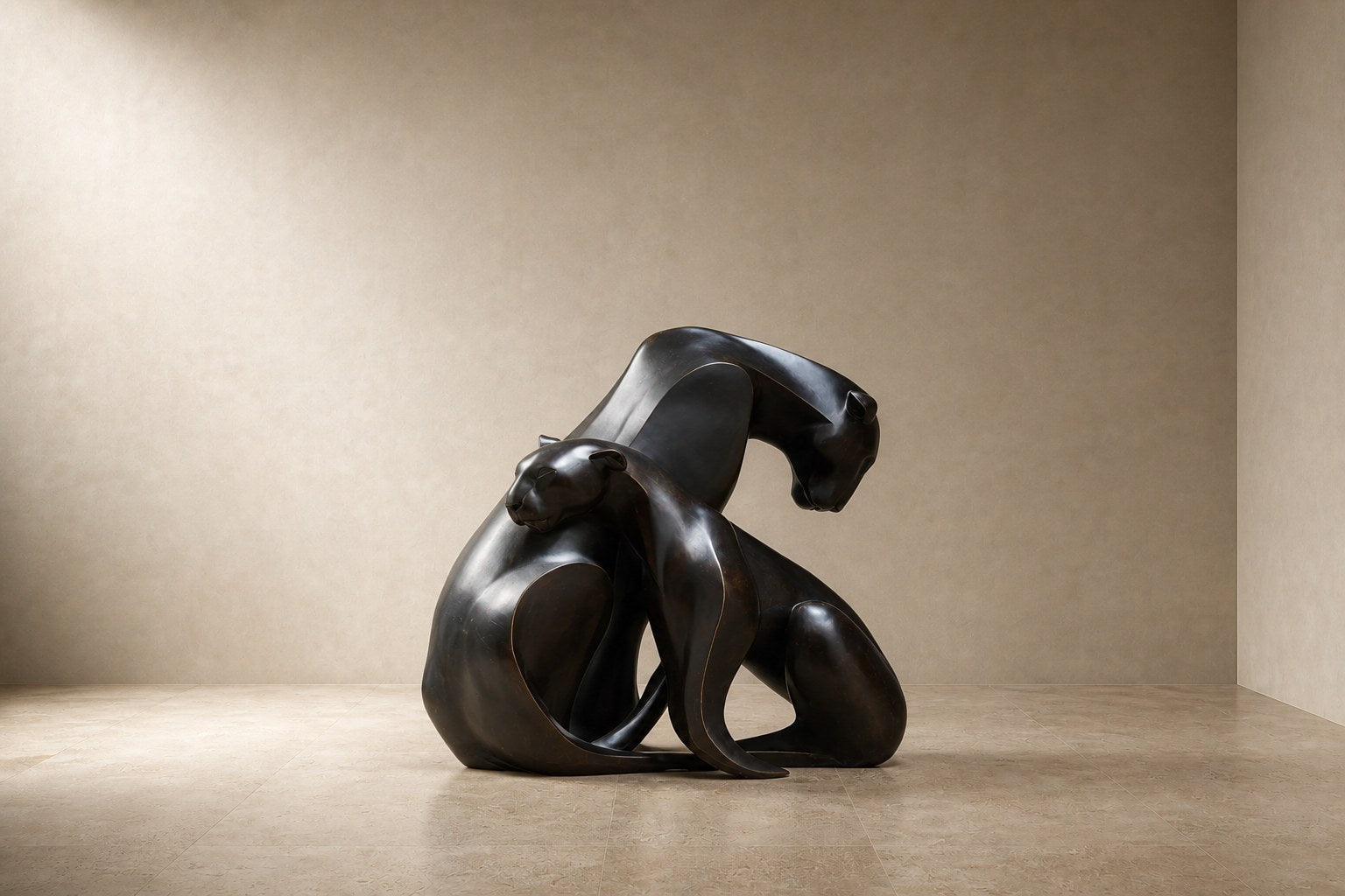 Near-black patinated bronze sculpture Pedregal, two big-cat figures entwined as a single mass, shown on a travertine display plinth.