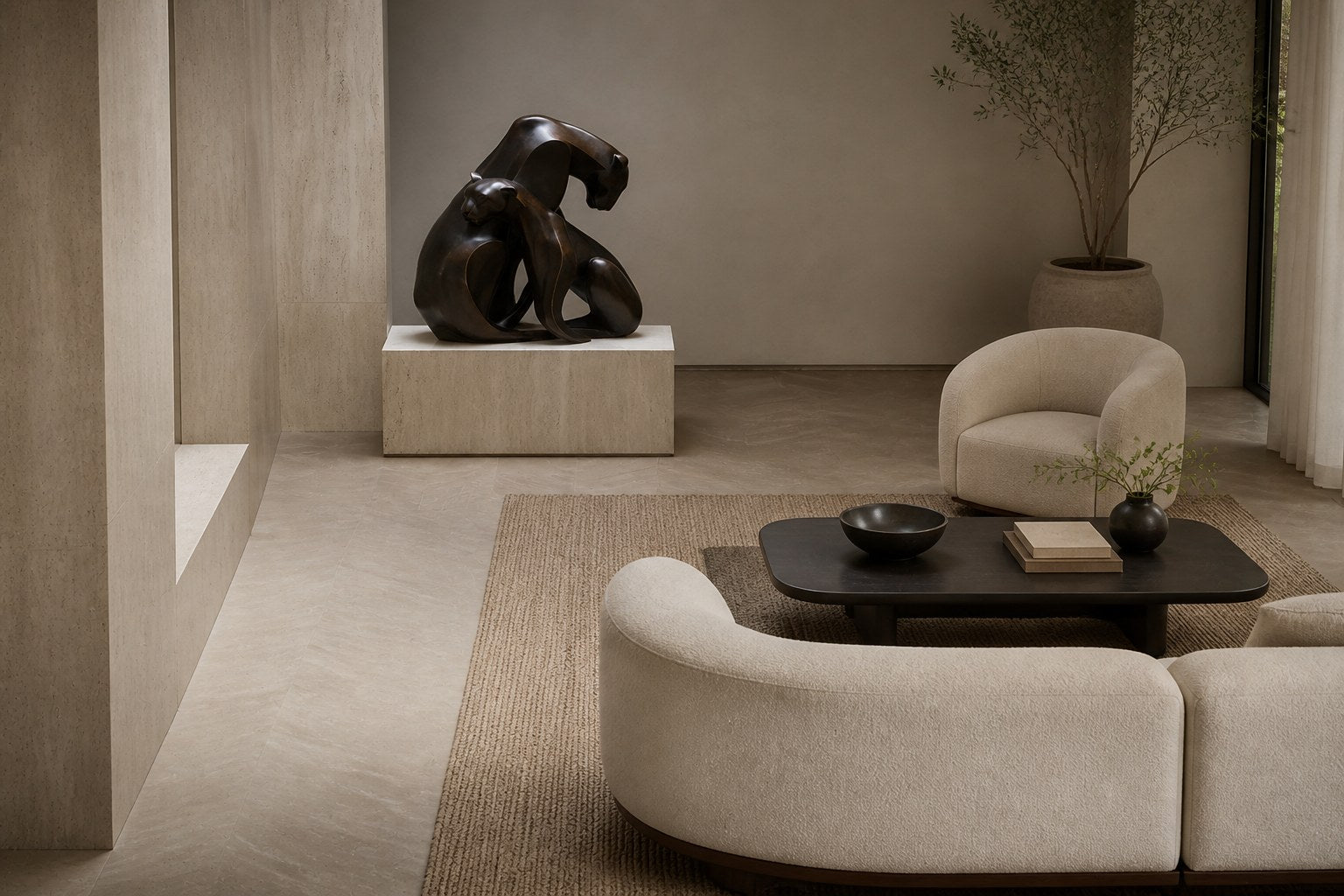 Near-black patinated bronze sculpture Pedregal, two big-cat figures entwined as a single mass, shown on a travertine display plinth.