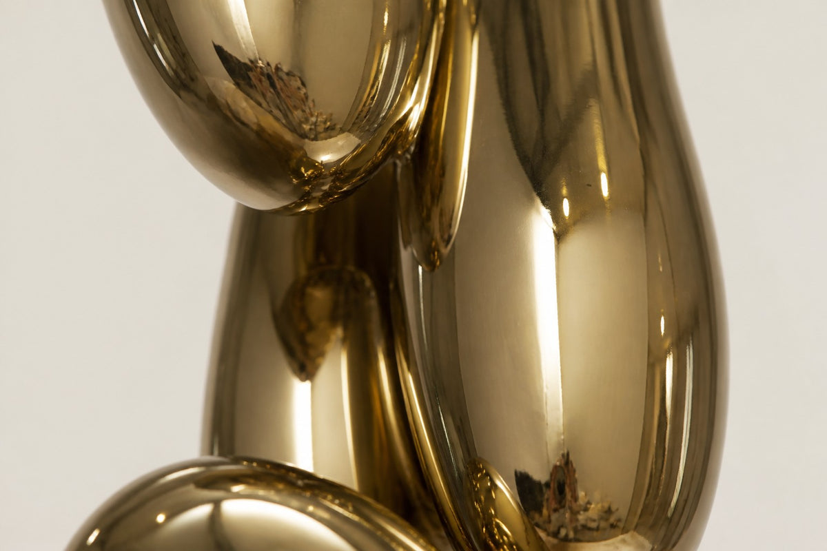 Pukyu — column of seven mirror-gold bubbles on a black base, close detail of the surface and edge