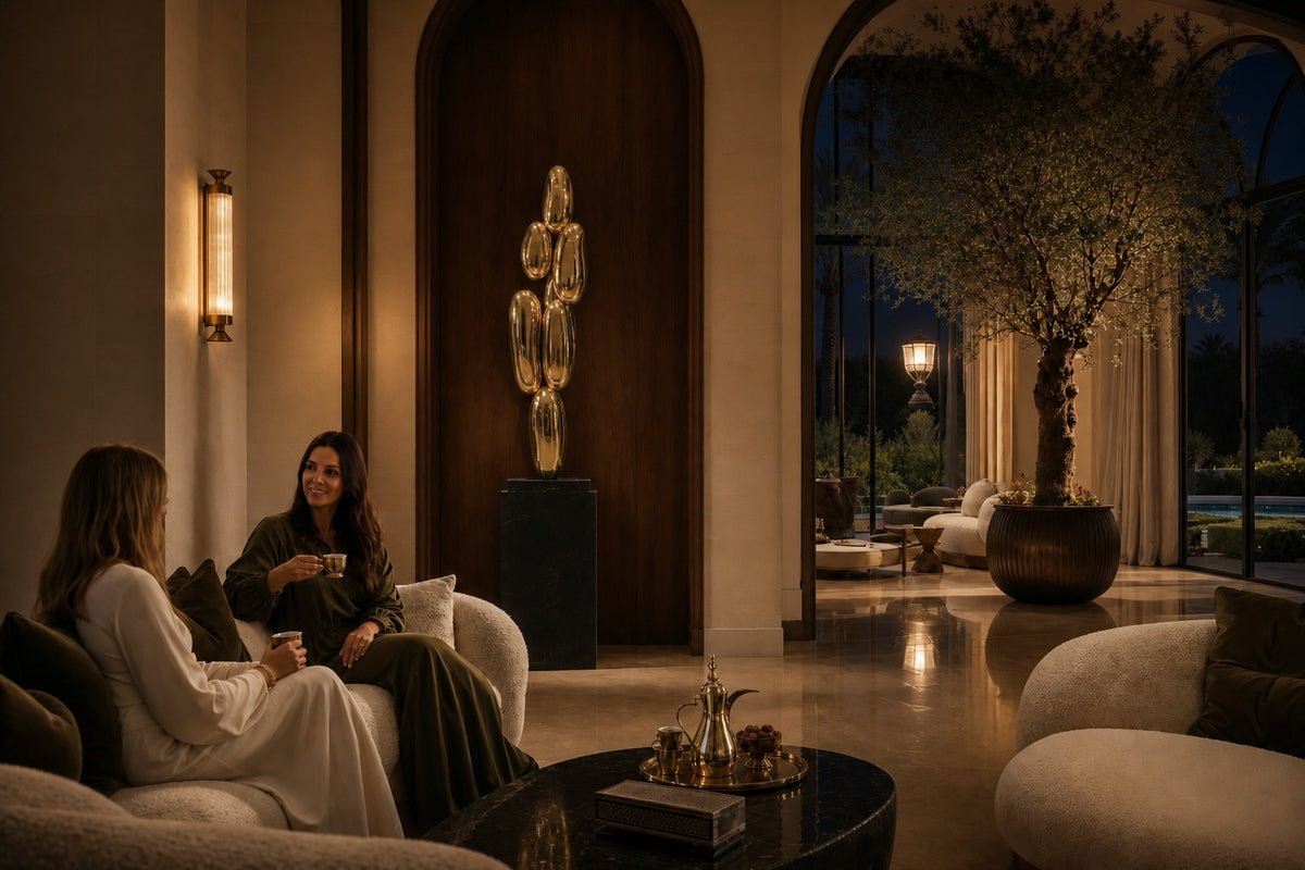 Pukyu — column of seven mirror-gold bubbles on a black base, the same room at night, lamps on