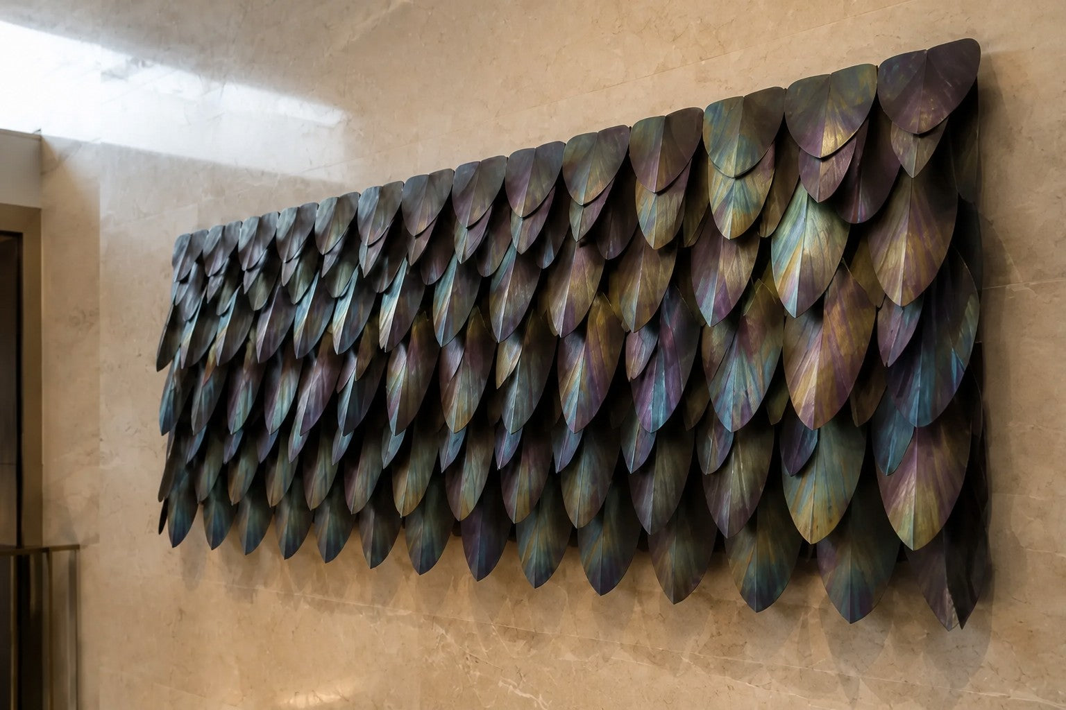 Rust orange and umber bronze wall sculpture Corteza, cast bark-textured plates shingled across a long rail, on a plaster wall.