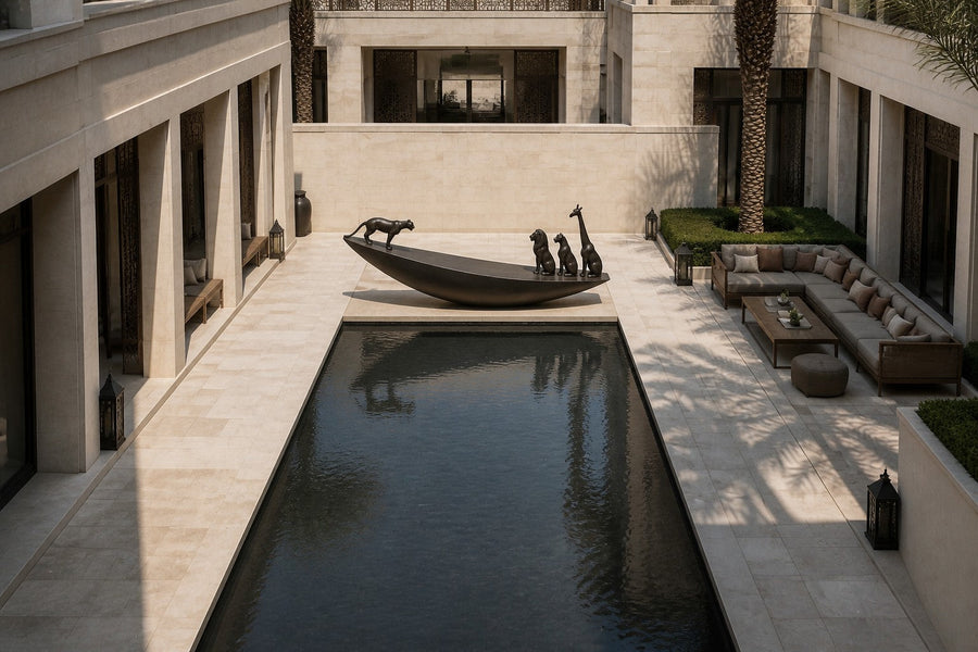 Dark bronze crescent sculpture Quebrada balanced on its curve, three seated forms at the high end and one walking down the fall.