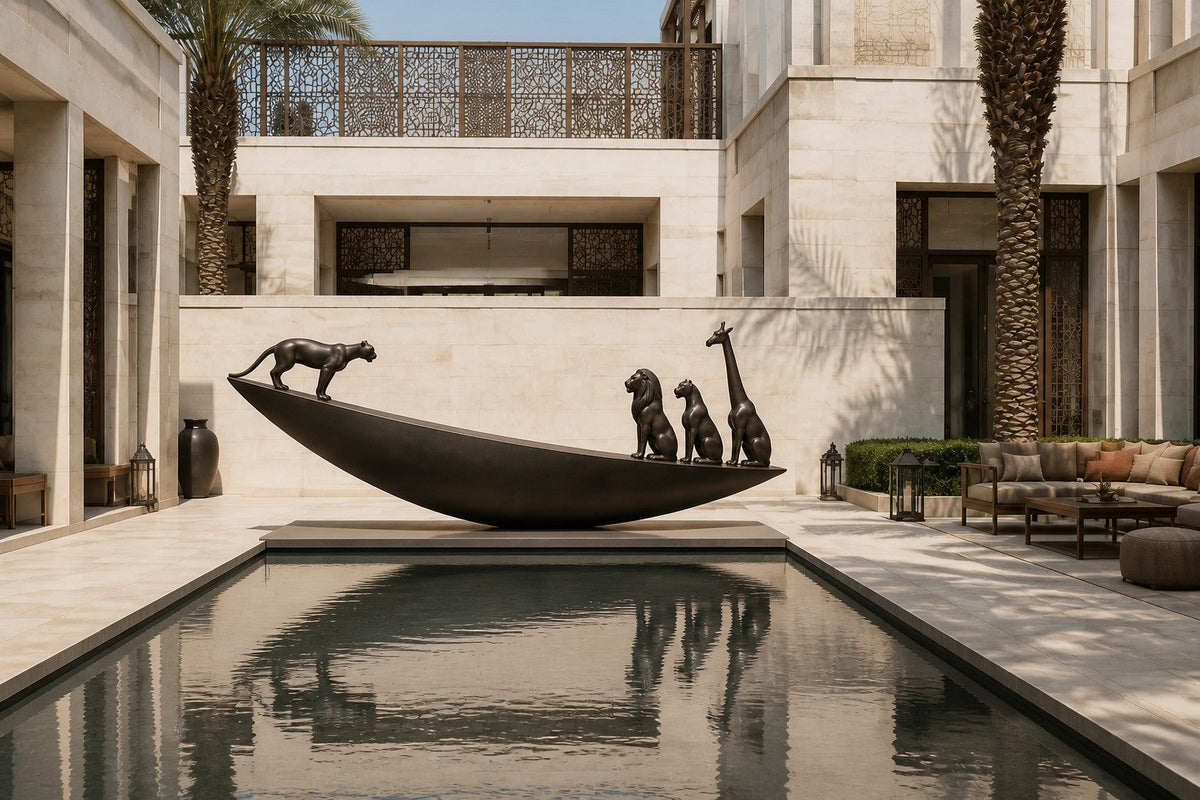 Dark bronze crescent sculpture Quebrada balanced on its curve, three seated forms at the high end and one walking down the fall.