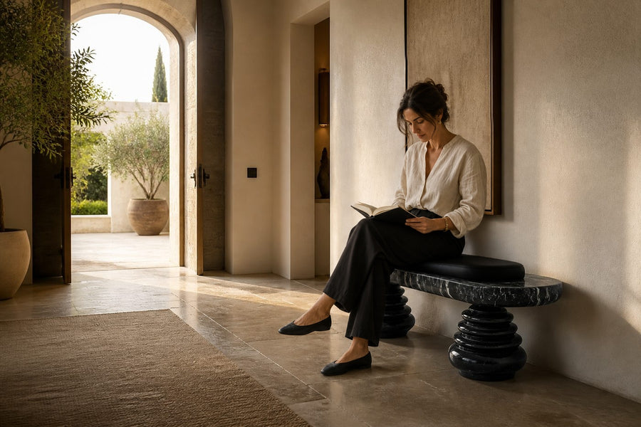 Quies stone sculptural bench, shown in a room setting, at full scale