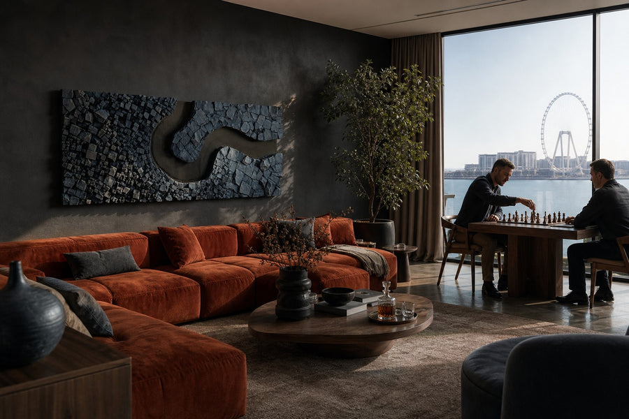 Recodo — slate stone block wall relief with a bronze river bend, installed on the wall of a furnished room