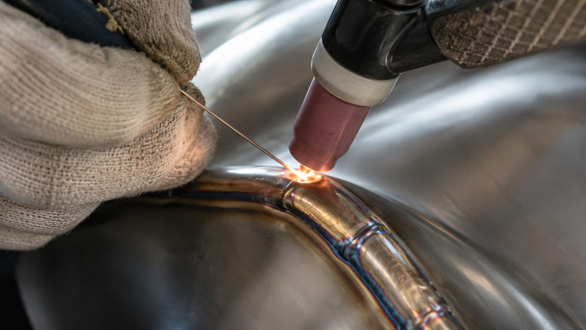 TIG welding a stainless steel ribbon at the 1-OPH workshop