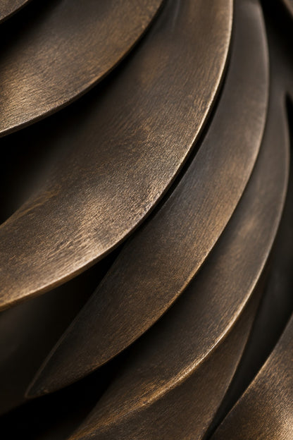 Warm brass and gold brass wall sculpture Sabuh, slender rods of graded length on a concealed spine, on a plaster wall.