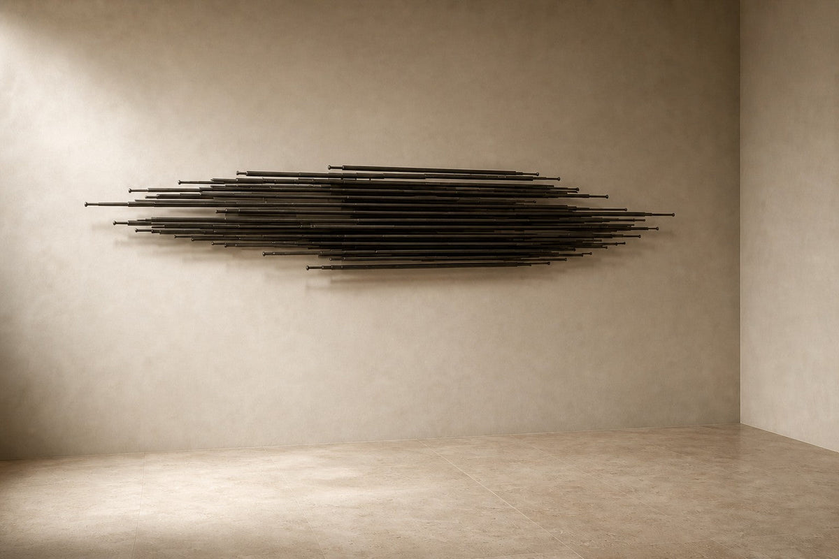 Saeta — 200 × 45 cm long horizontal sheaf of blackened steel blades, three-quarter studio view showing its profile