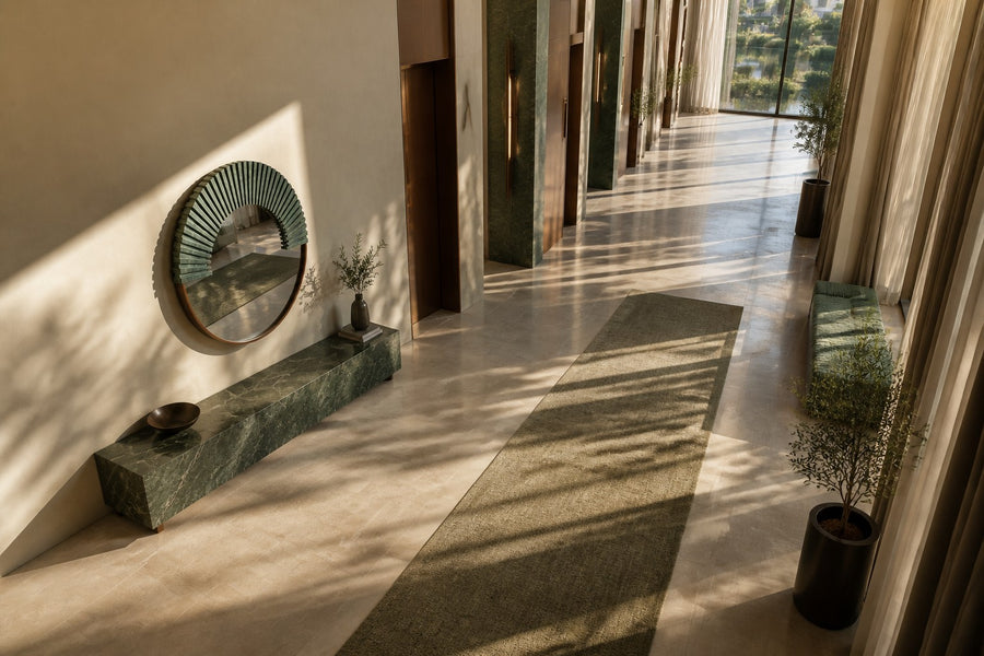 Sana — Ø 140 cm round wall mirror with a verdigris bronze sunburst, seen from above in the room