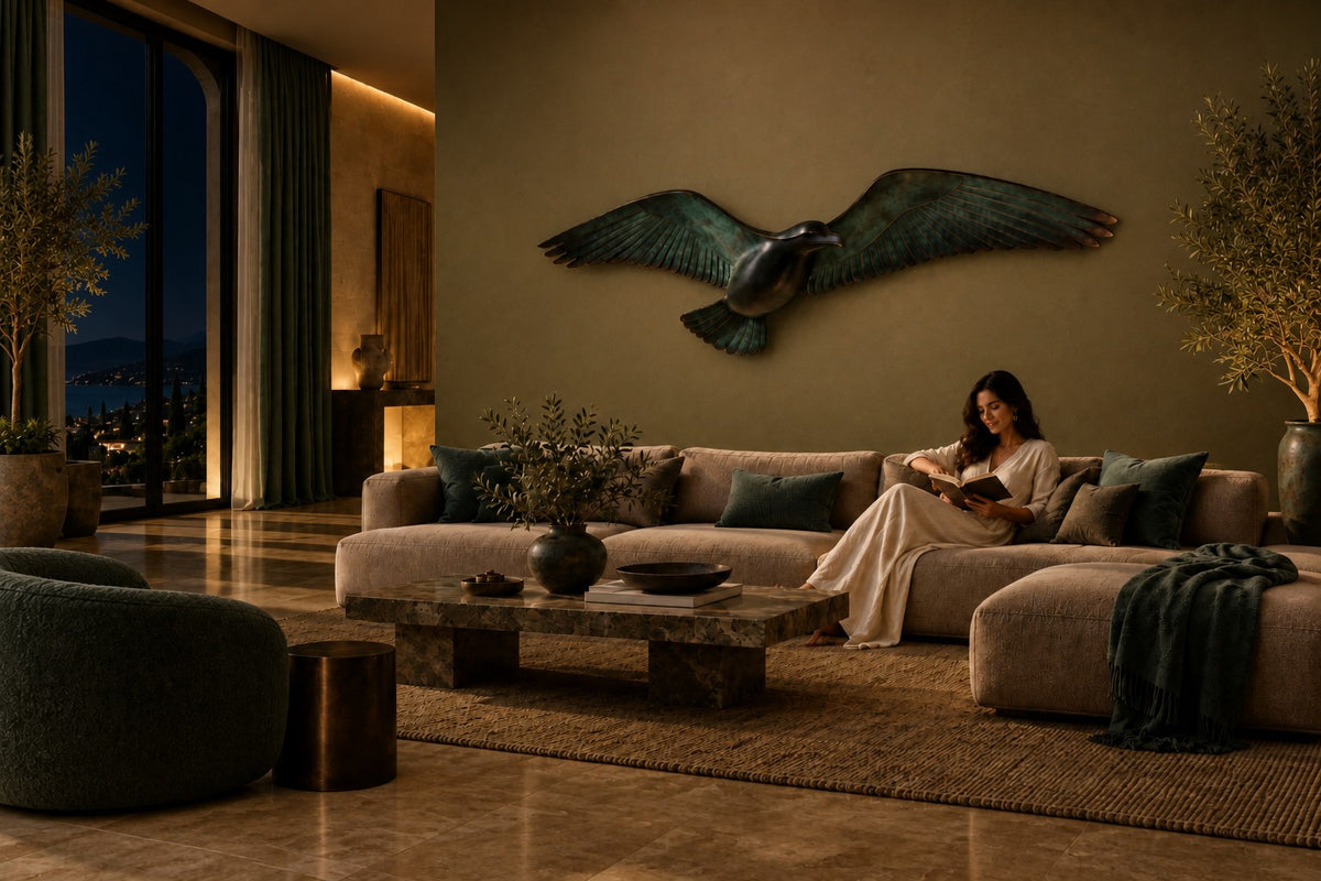 Saqr — verdigris bronze falcon in flight wall sculpture, the same room at night, lamps on