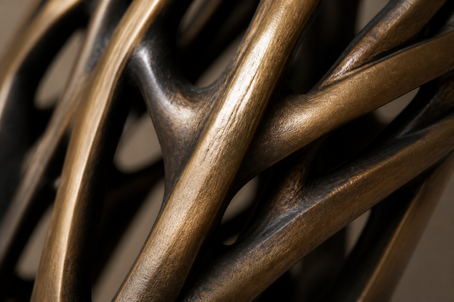 Bronze strut-cage sculpture Sbalzo forming an inverted arch, gilt and blackened, on a beaded travertine block.