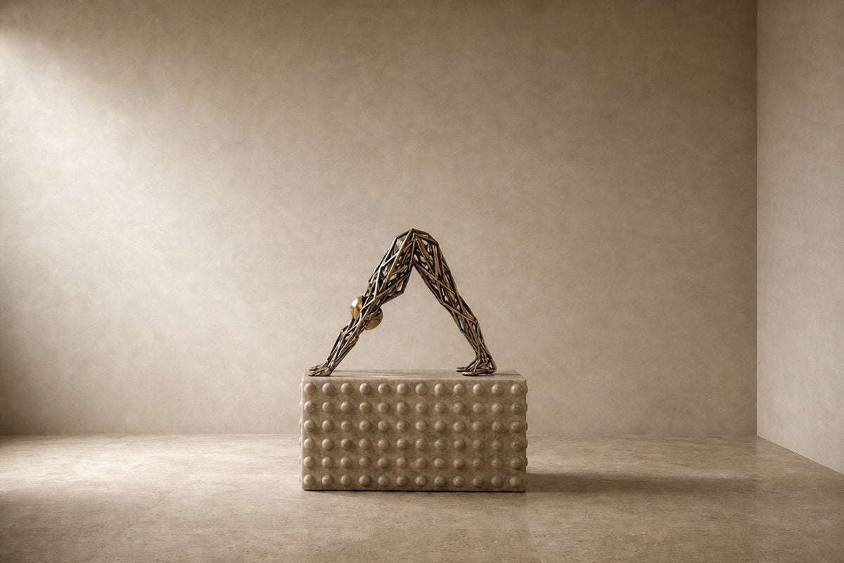 Bronze strut-cage sculpture Sbalzo forming an inverted arch, gilt and blackened, on a beaded travertine block.