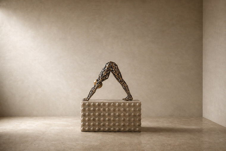 Bronze strut-cage sculpture Sbalzo forming an inverted arch, gilt and blackened, on a beaded travertine block.
