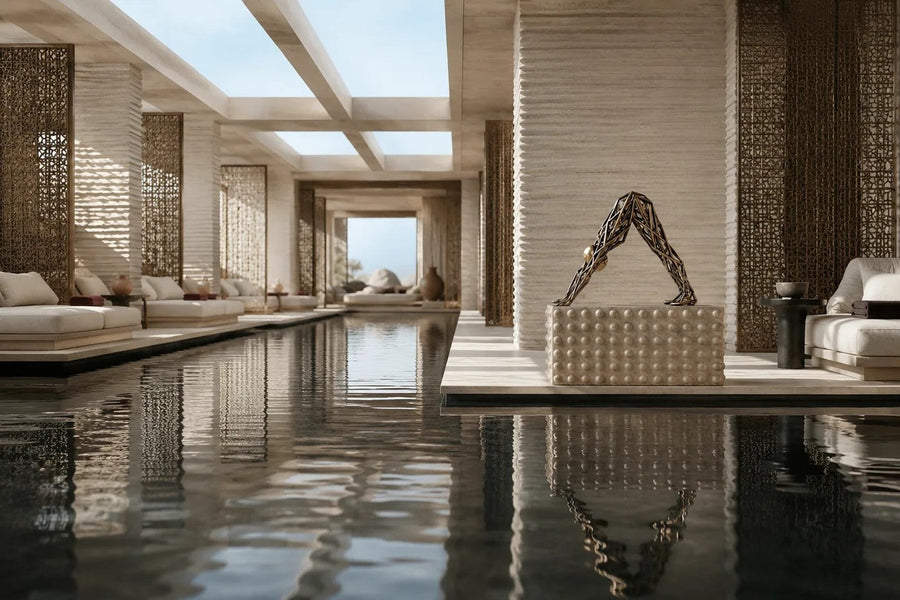 Bronze strut-cage sculpture Sbalzo forming an inverted arch, gilt and blackened, on a beaded travertine block.
