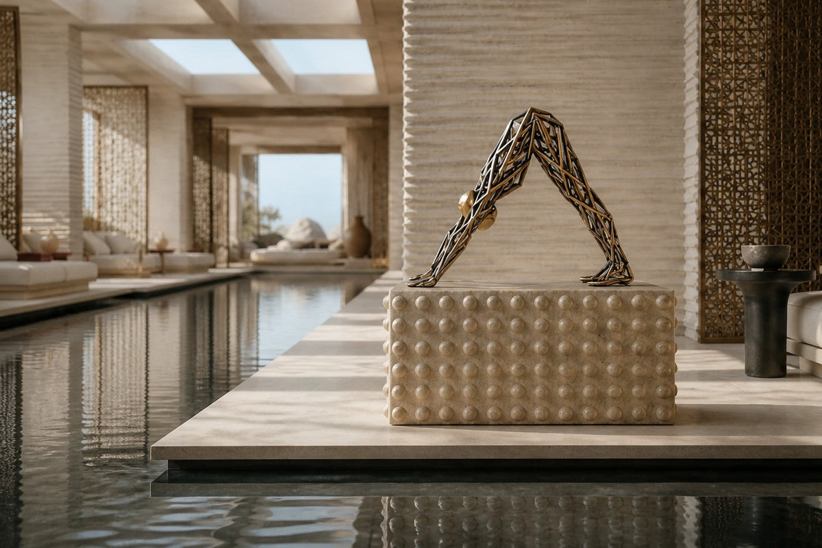 Bronze strut-cage sculpture Sbalzo forming an inverted arch, gilt and blackened, on a beaded travertine block.
