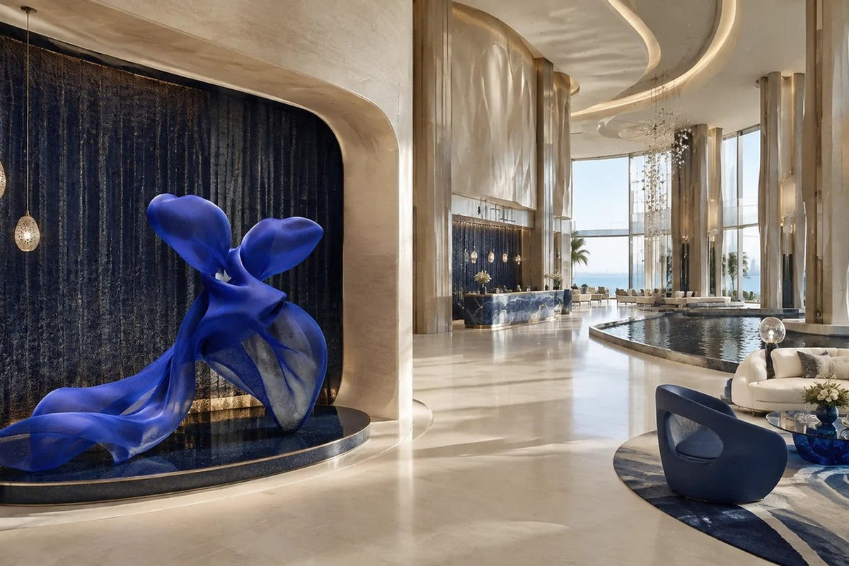 Cobalt blue woven wire sculpture Shaula, a draped form with two raised lobes and a long sweep trailing to the floor.