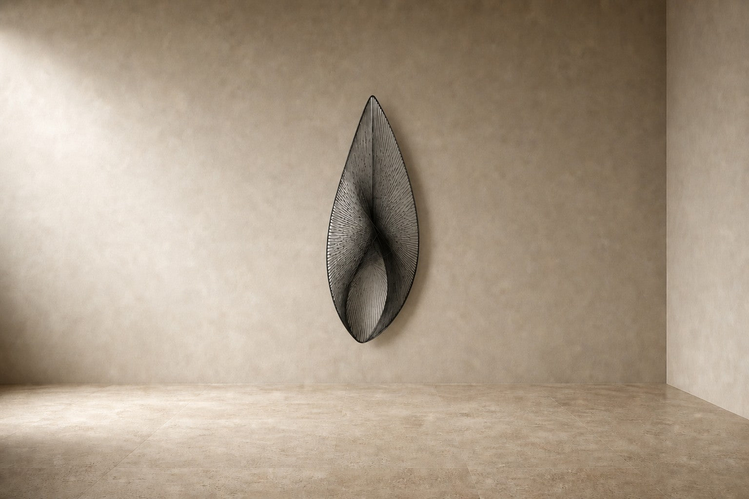 Satin steel steel wall sculpture Punta, a tapered leaf blade on a concealed bracket, on a plaster wall.
