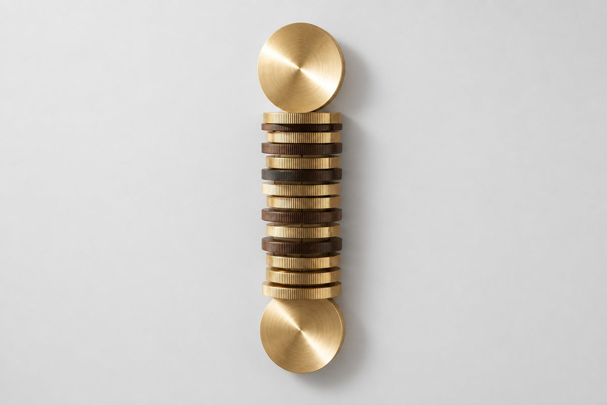 Solana — vertical brass and bronze disc column wall sculpture, studio front view