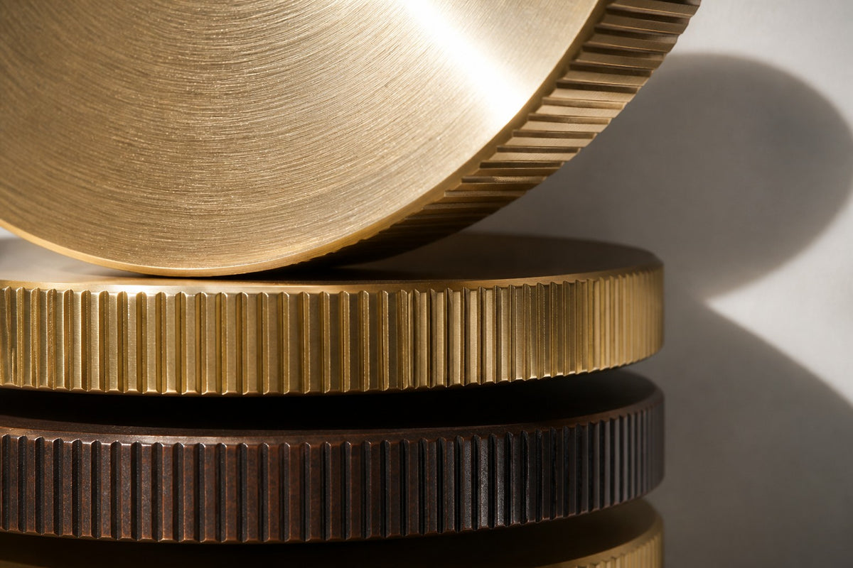 Solana — vertical brass and bronze disc column wall sculpture, close detail of the surface and edge
