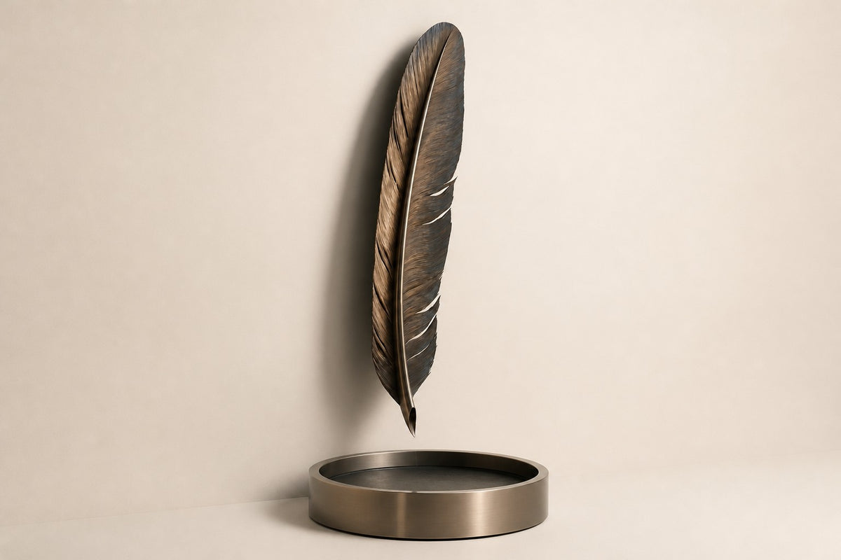 Solenne — bronze feather wall fountain, studio side angle showing its depth