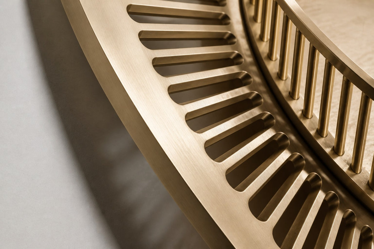 Stoa — Ø 200 cm brushed brass circular wall relief with a ring of slender columns around an engraved floor, close studio detail of the surface and material