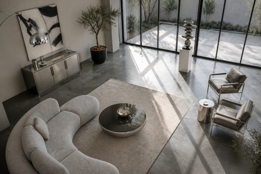 Suiseki — mirror chrome stacked pebble sculpture on a black base, seen from above in the room