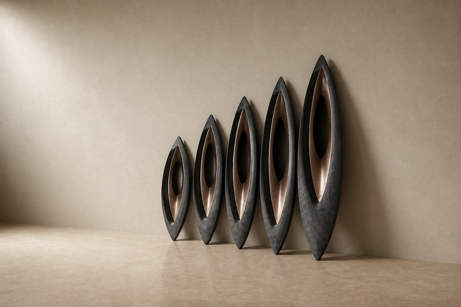 Five graduated lens-shaped bronze forms in ascending order, leaning against a plaster wall.