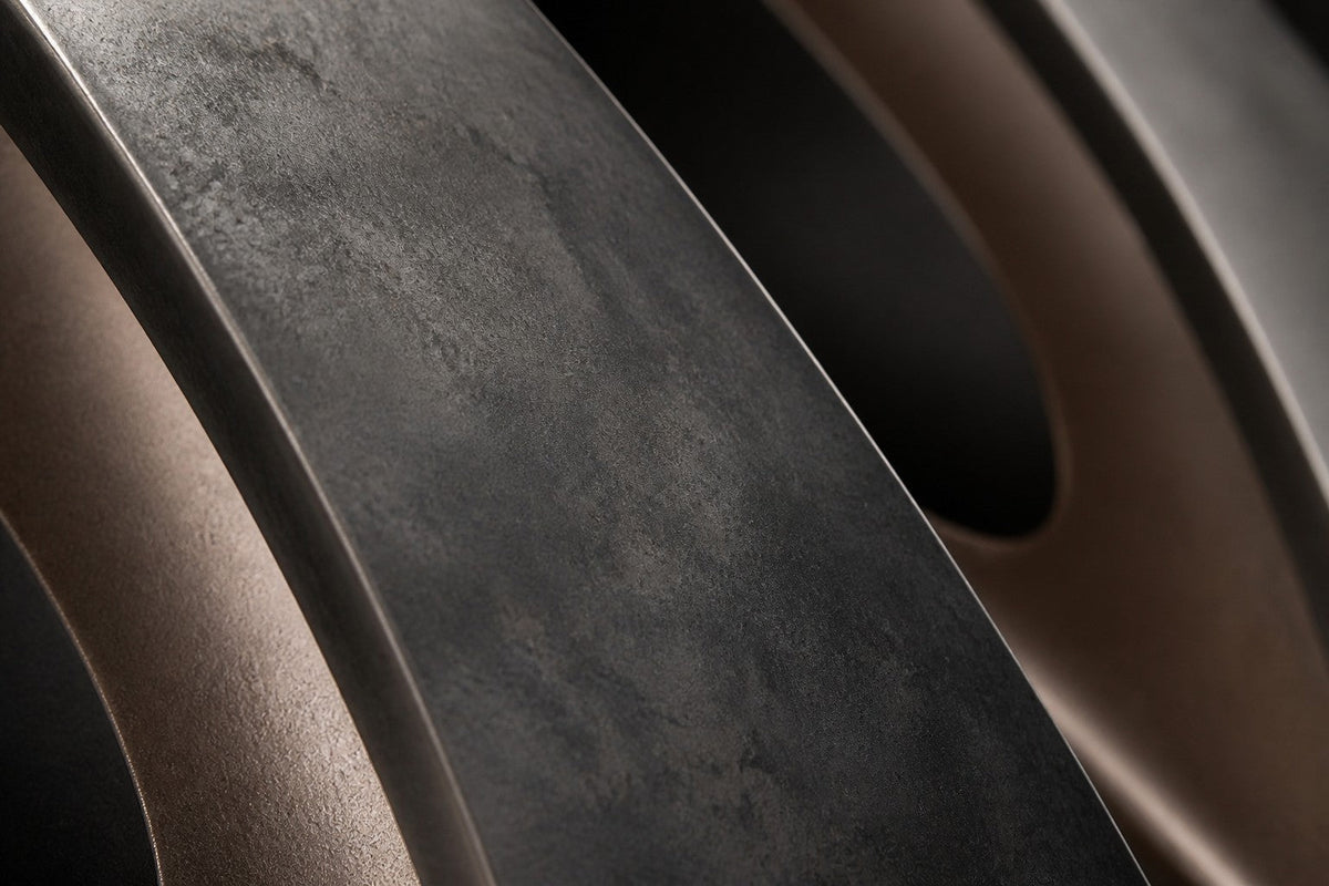 Tayf — 210 × 60 cm wall sculpture of five dark bronze pointed ovals with polished linings, close studio detail of the surface and material