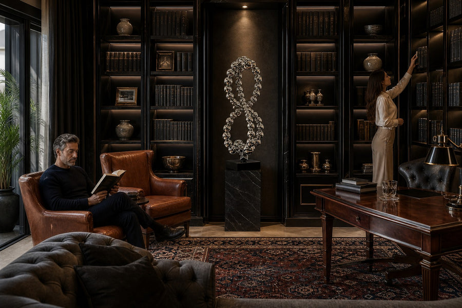 Thuraya — mirror chrome beaded figure-eight sculpture on a black base, placed in a furnished room