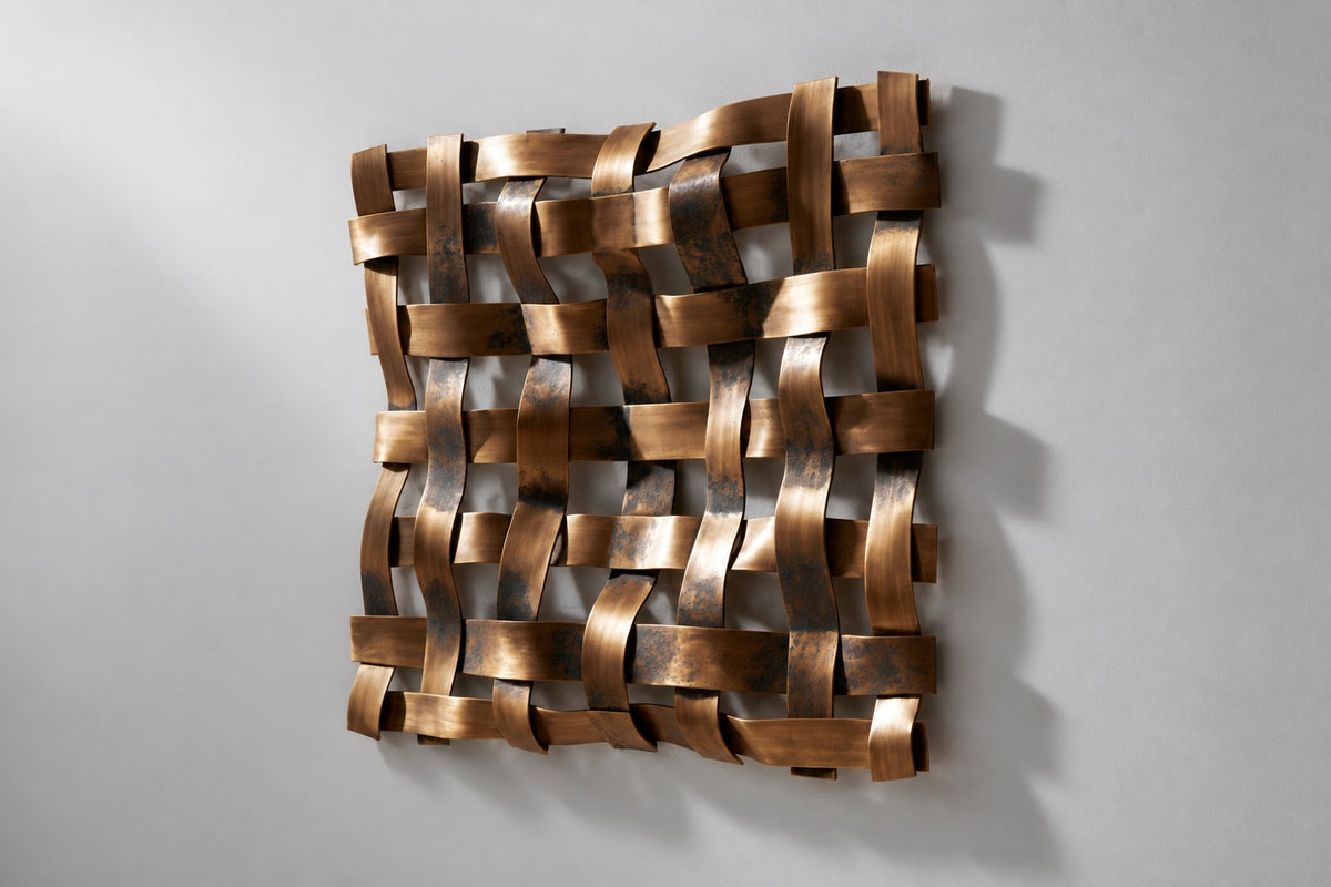 Trama — woven brass strip square wall sculpture, studio side angle showing its depth