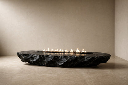 Black basalt fire table Tsukage 220, dense black with fine grey veining, on a pale stone floor.
