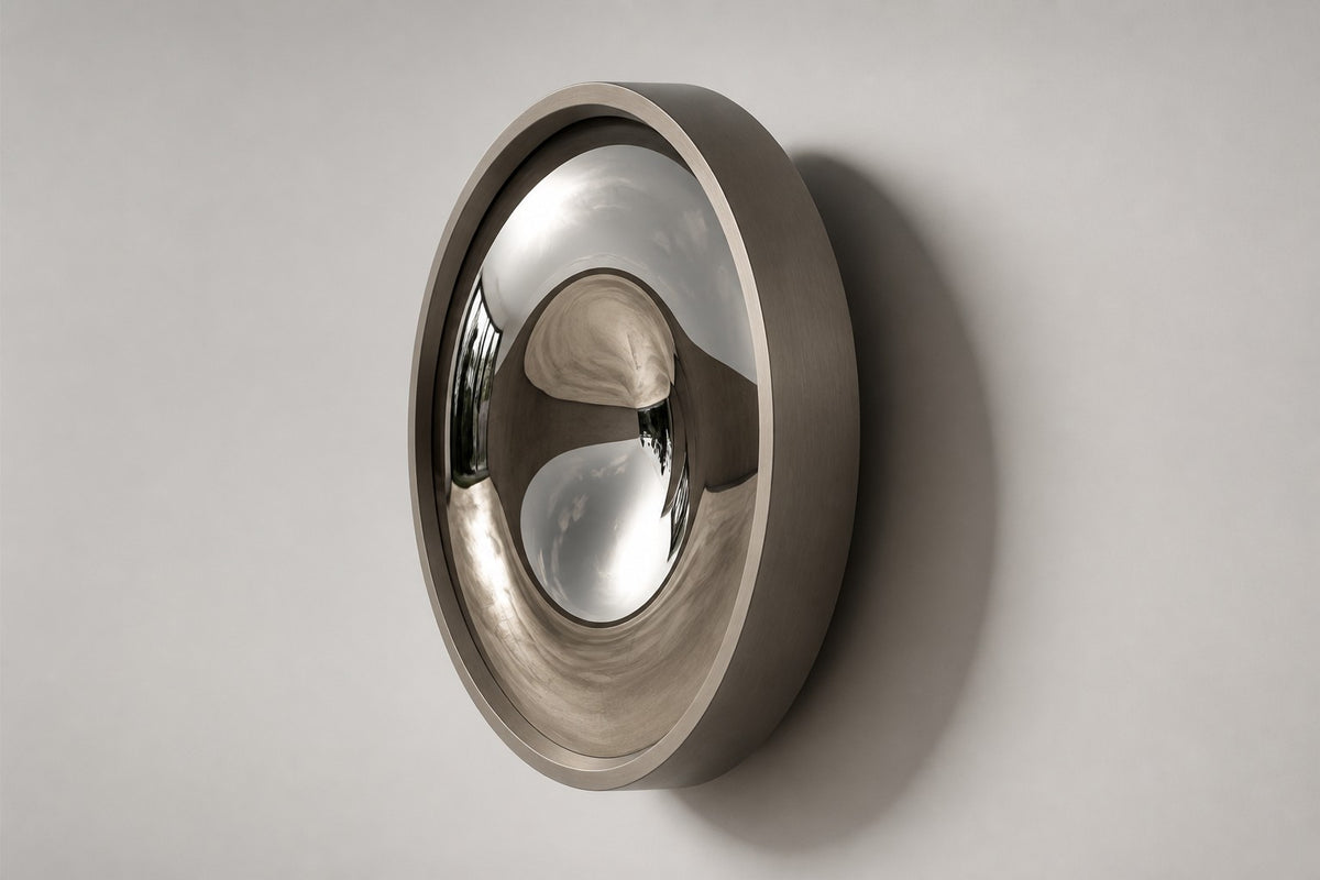 Tsuki — Ø 160 cm concave mirror stainless steel moon wall sculpture, studio side angle showing its depth