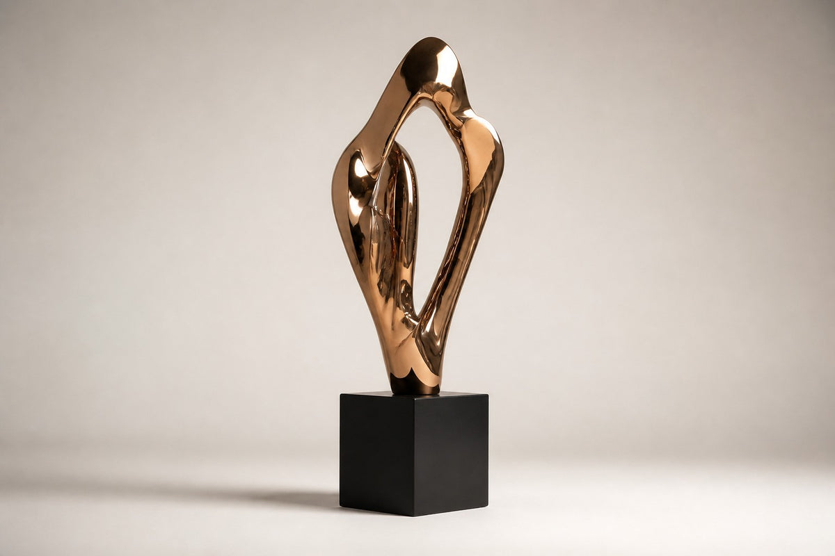 Vega — polished rose bronze abstract wing sculpture on a black base, studio side angle showing its depth
