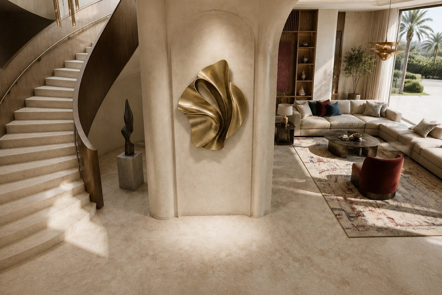 Ventaglio — 100 × 120 cm champagne brass wall sculpture of a folded fan, seen from above in the room