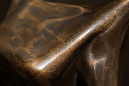 Patinated bronze figure sculpture Voluta, one arm arced overhead into a closed loop, on a small bronze block base.