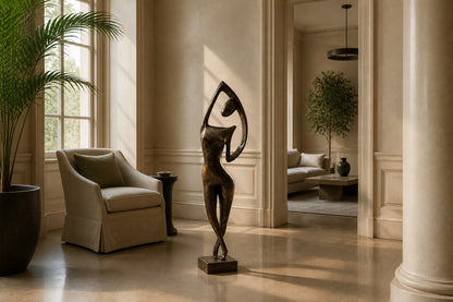 Patinated bronze figure sculpture Voluta, one arm arced overhead into a closed loop, on a small bronze block base.