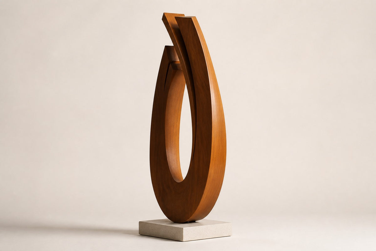 Wahja — 200 cm weathered Corten steel open teardrop loop sculpture on a low stone plinth, three-quarter studio view showing its profile