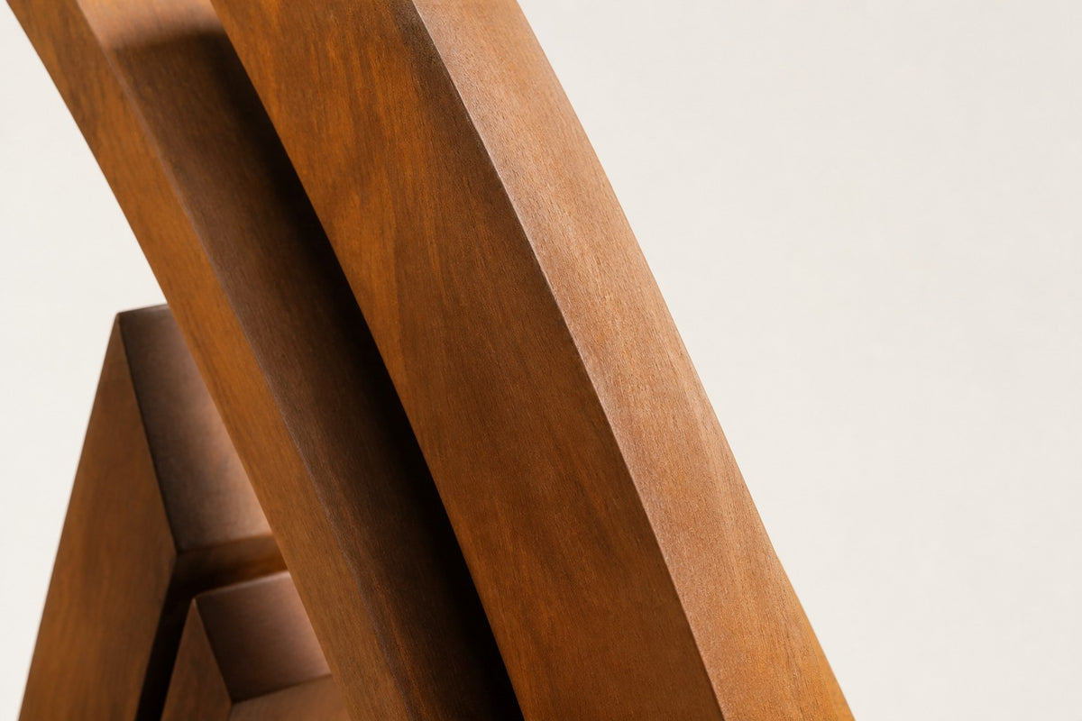 Wahja — 200 cm weathered Corten steel open teardrop loop sculpture on a low stone plinth, close studio detail of the surface and material