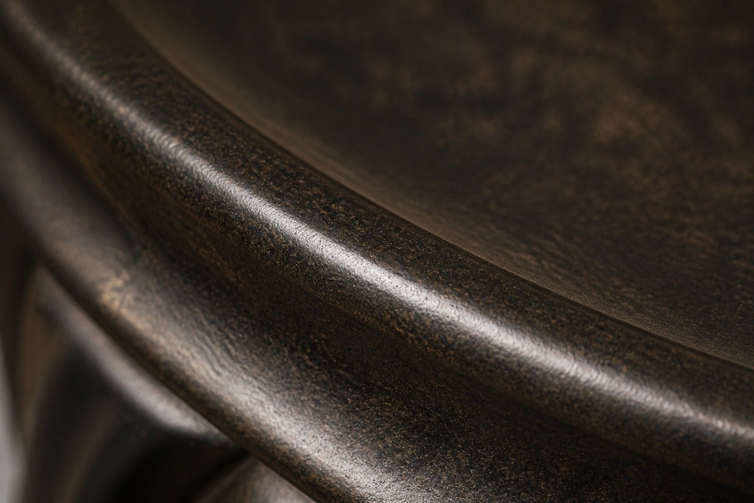 Stone pedestal fountain Wayrana Ø65, dark bronze, on a pale stone floor.