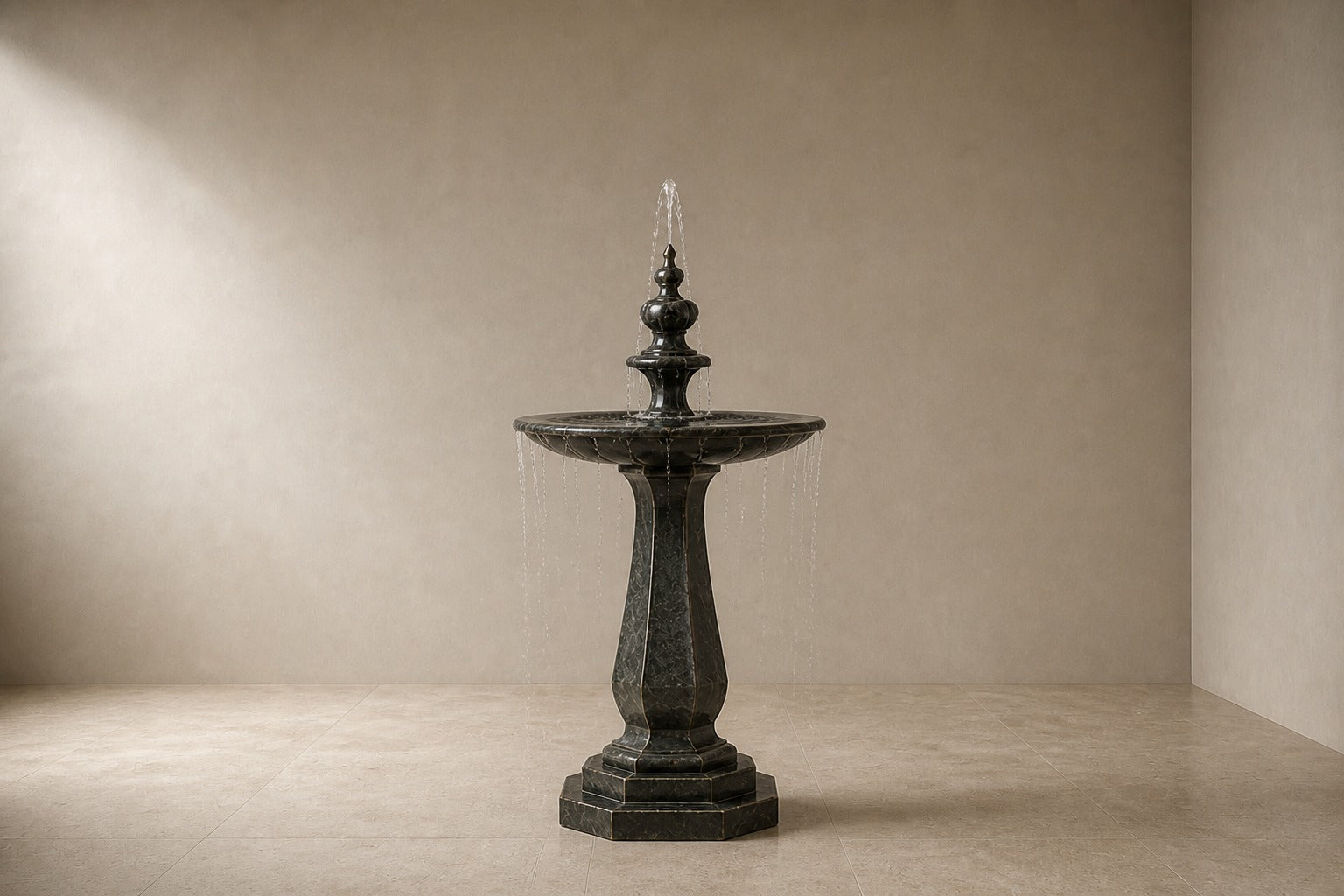Stone pedestal fountain Yakura Ø65, dark green-black, on a pale stone floor.