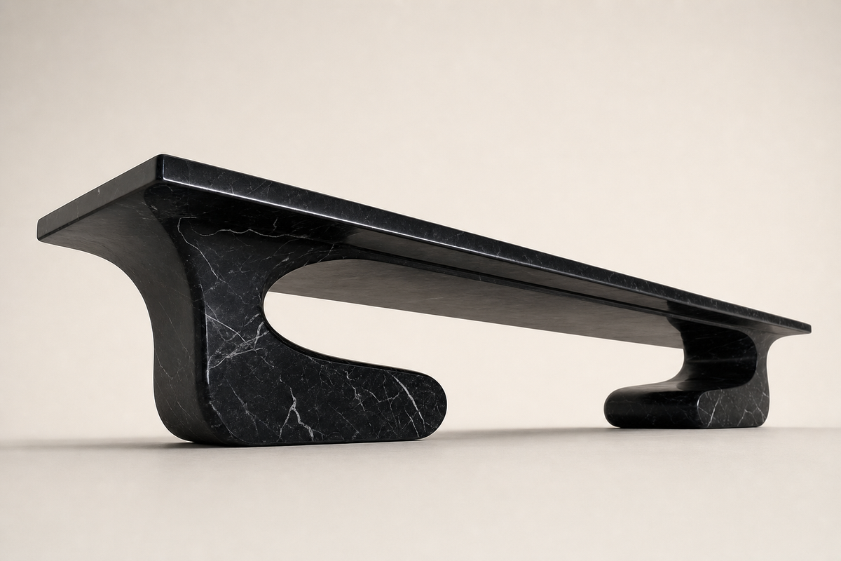 Yutori 180 stone sculptural bench, three-quarter studio view showing its profile