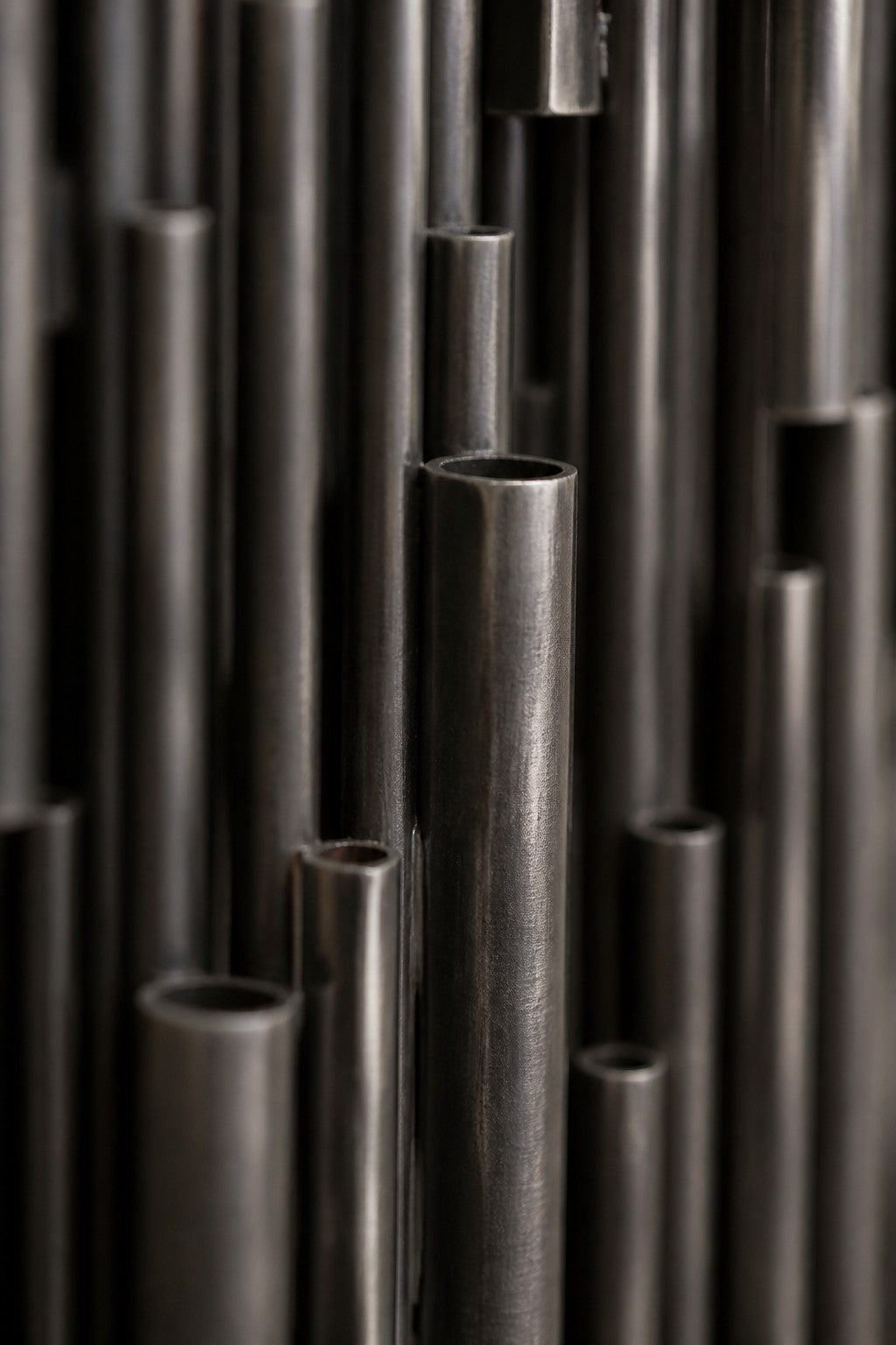 Zulal 150 — 150 cm wall panel of dark stainless steel strands, close studio detail of the surface and material